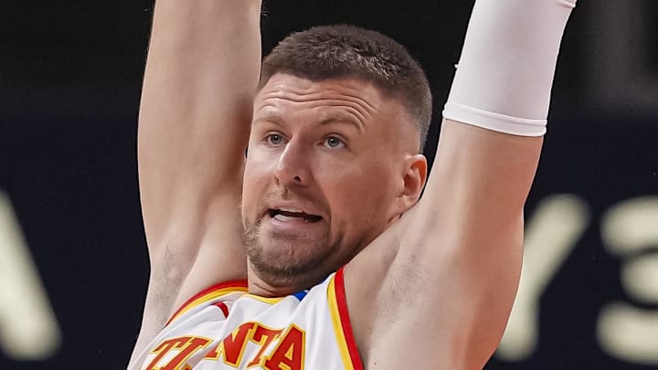Jan 7, 2026; Atlanta, Georgia, USA; Atlanta Hawks center Kristaps Porzingis (8) reaches for a pass over New Orleans Pelicans guard Jordan Poole (3) during the first half at State Farm Arena. Mandatory Credit: Dale Zanine-Imagn Images
