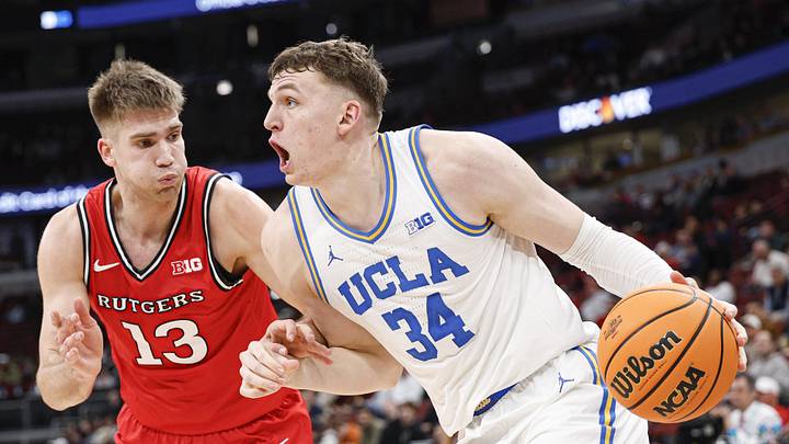 Mar 12, 2026; Chicago, IL, USA; UCLA Bruins forward Tyler Bilodeau (34) drives to the basket against Rutgers Scarlet Knights guard Harun Zrno (13) during the second half at United Center. Mandatory Credit: Kamil Krzaczynski-Imagn Images