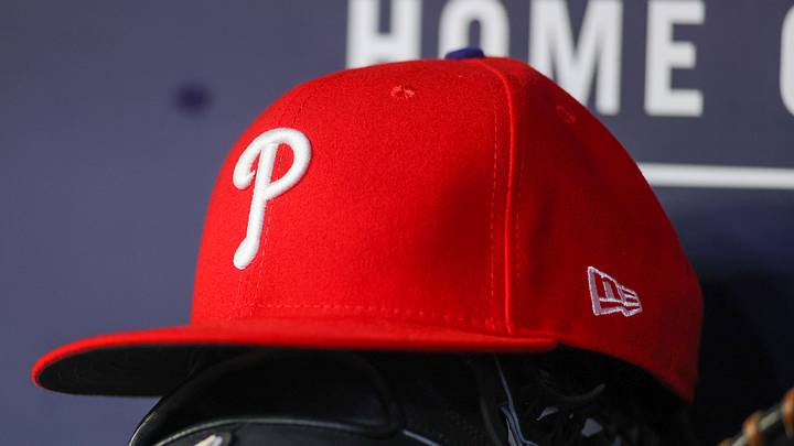 May 26, 2023; Atlanta, Georgia, USA; A detailed view of a Philadelphia Phillies hat and glove on the bench against the Atlanta Braves in the seventh inning at Truist Park. 