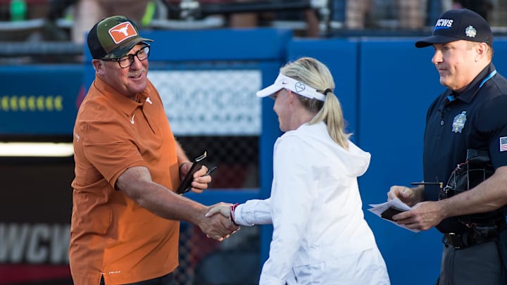 Texas head coach Mike White shakes hands with Oklahoma head coach Patty Gasso ahead of a meeting at the Women's College World Series. Texas head coach Mike White shakes hands with Oklahoma head coach Patty Gasso ahead of a meeting at the Women's College World Series.