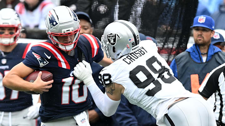 Sep 7, 2025; Foxborough, Massachusetts, USA; New England Patriots quarterback Drake Maye (10) rushes the ball against Las Vegas Raiders defensive end Maxx Crosby (98) in the first half at Gillette Stadium. Mandatory Credit: Brian Fluharty-Imagn Images