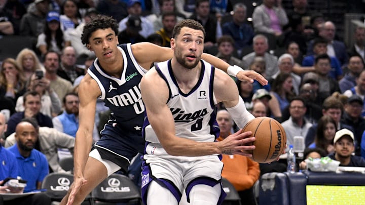 Mar 3, 2025; Dallas, Texas, USA; Sacramento Kings guard Zach LaVine (8) drives to the basket past Dallas Mavericks guard Max Christie (00) during the second half at the American Airlines Center. Mandatory Credit: Jerome Miron-Imagn Images