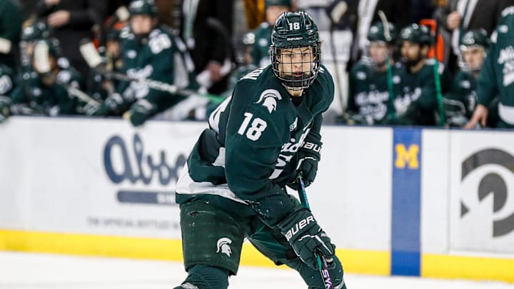 Michigan State right wing Joey Larson looks to pass against Michigan during the third period at Yost Ice Arena in Ann Arbor on Friday, Feb. 9, 2024.