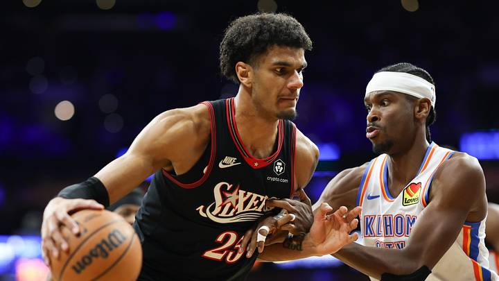 Mar 23, 2026; Philadelphia, Pennsylvania, USA; Philadelphia 76ers forward Dominick Barlow (25) controls the ball against Oklahoma City Thunder guard Shai Gilgeous-Alexander (2) during the second quarter at Xfinity Mobile Arena. 
