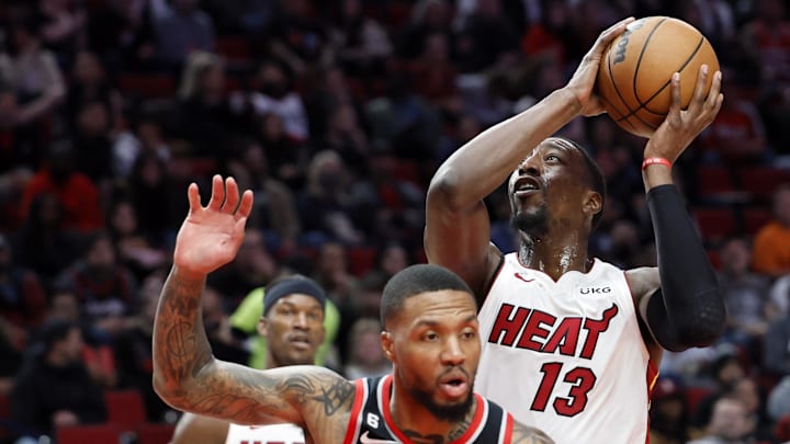 Miami Heat center Bam Adebayo drives to the basket past Portland Trail Blazers point guard Damian Lillard.