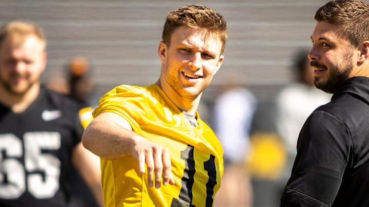 Apr 26, 2025; Iowa City, IA, USA; Iowa quarterback Mark Gronowski (11) talks with defensive lineman Ethan Hurkett (49) during a spring NCAA football open practice at Kinnick Stadium. Mandatory Credit: Joseph Cress/For the Register