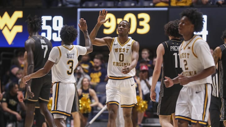 Mar 6, 2026; Morgantown, West Virginia, USA; West Virginia Mountaineers forward Brenen Lorient (0) celebrates with West Virginia Mountaineers guard Honor Huff (3) during the second half against the UCF Knights at Hope Coliseum.