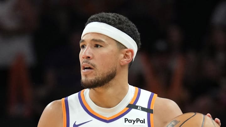 Apr 11, 2025; Phoenix, Arizona, USA; Phoenix Suns guard Devin Booker (1) dribbles against the San Antonio Spurs during the second half at Footprint Center. Mandatory Credit: Joe Camporeale-Imagn Images