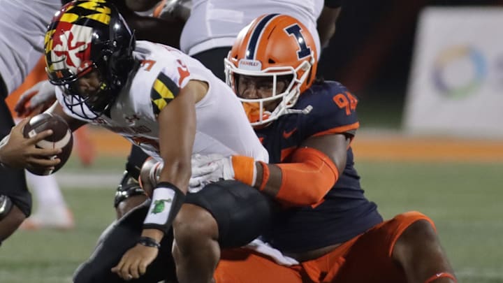 Sep 17, 2021; Champaign, Illinois, USA; Illinois Fighting Illini defensive lineman Jer'Zhan Newton (94) sacks Maryland Terrapins quarterback Taulia Tagovailoa (3) in the first half at Memorial Stadium. Mandatory Credit: Ron Johnson-Imagn Images