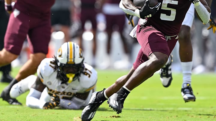 Oct 5, 2024; College Station, Texas, USA; Texas A&M Aggies running back Amari Daniels (5) runs the ball in the first quarter against the Missouri Tigers at Kyle Field. Mandatory Credit: Maria Lysaker-Imagn Images. 