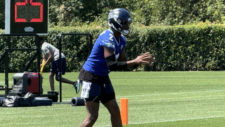 Seattle Seahawks quarterback Geno Smith takes a snap during a drill at training camp. Seattle Seahawks quarterback Geno Smith takes a snap during a drill at training camp.