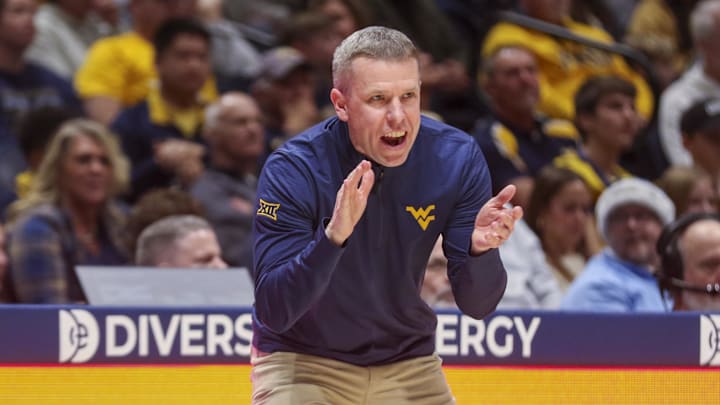 Dec 22, 2025; Morgantown, West Virginia, USA; West Virginia Mountaineers head coach Ross Hodge claps during the first half against the Mississippi Valley State Delta Devils at Hope Coliseum. Mandatory Credit: Ben Queen-Imagn Images