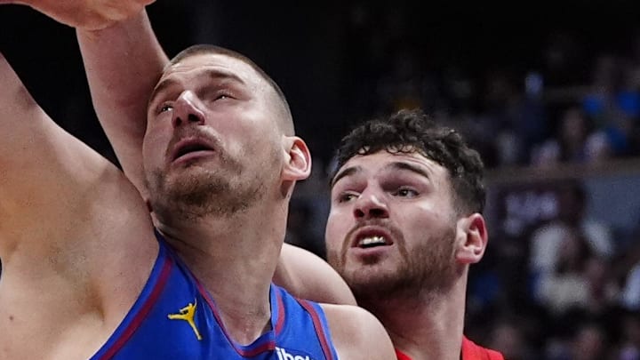 Portland Trail Blazers center Donovan Clingan and Denver Nuggets center Nikola Jokic.