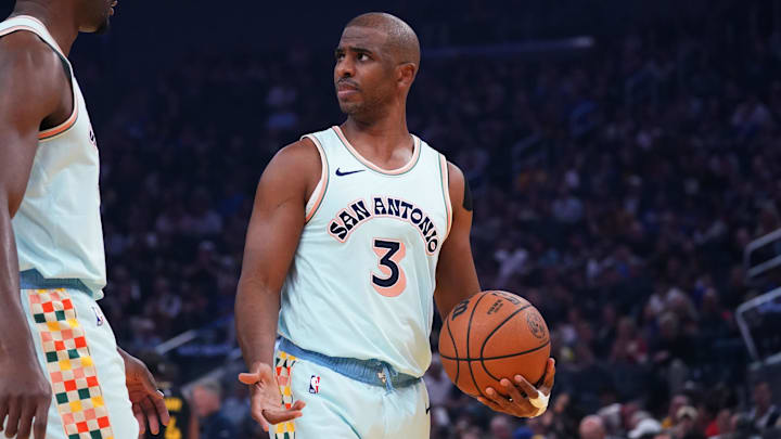 Free agent San Antonio Spurs guard Paul talks with Biyombo during a game