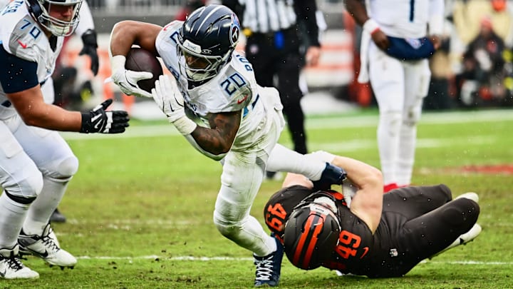 Dec 7, 2025; Cleveland, Ohio, USA; Cleveland Browns linebacker Carson Schwesinger (49) tackles Tennessee Titans running back Tony Pollard (20) during the first quarter at Huntington Bank Field. Mandatory Credit: Ken Blaze-Imagn Images