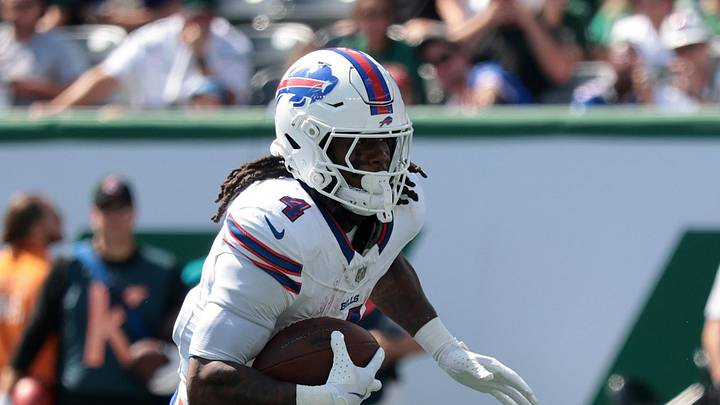 Sep 14, 2025; East Rutherford, New Jersey, USA; Buffalo Bills running back James Cook (4) rushes the ball against the New York Jets during the first half at MetLife Stadium. Mandatory Credit: Vincent Carchietta-Imagn Images