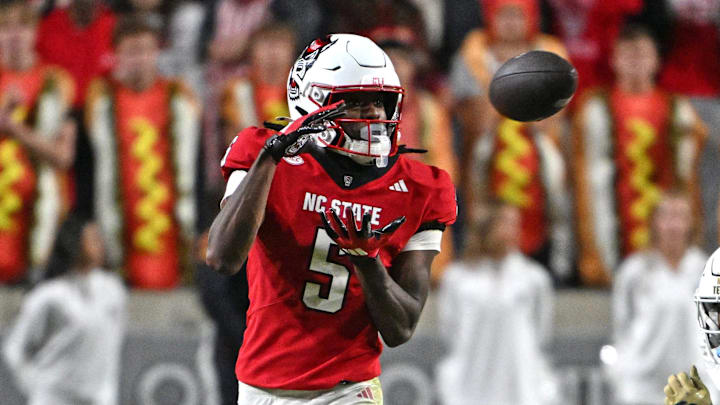 Nov 1, 2025; Raleigh, North Carolina, USA;  North Carolina State Wolfpack wide receiver Noah Rogers (5) catches a pass during the second quarter against Georgia Tech Yellow Jackets defensive back Rodney Shelley (6) at Carter-Finley Stadium. Mandatory Credit: Zachary Taft-Imagn Images
