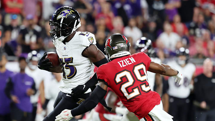 Oct 21, 2024; Tampa, Florida, USA; Baltimore Ravens wide receiver Nelson Agholor (15) runs with the ball as Tampa Bay Buccaneers safety Christian Izien (29) defends during the first half at Raymond James Stadium. Mandatory Credit: Kim Klement Neitzel-Imagn Images