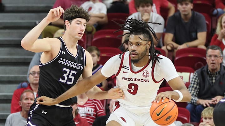 Arkansas' 6-foot-11 center Jonas Aidoo (9) drives against Lipscomb Bisons center Grant Asian (35) in the first half of the Razorbacks' 76-60 victory Wednesday at Bud Walton Arena. Aidoo, who is battling injury, has played just 15 minutes in two games this season.