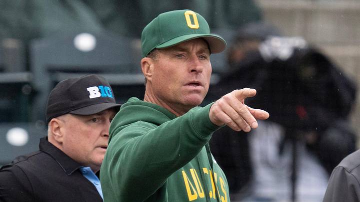 Oregon coach Mark Wasikowski, center, points out features of PK Park to Indiana coach Jeff Mercer before their game at PK Park in Eugene March 13, 2026.