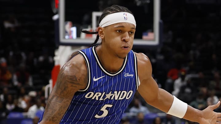 Nov 1, 2025; Washington, District of Columbia, USA; Orlando Magic forward Paolo Banchero (5) drives to the basket as Washington Wizards forward Cam Whitmore (1) defends in the first half at Capital One Arena. Mandatory Credit: Geoff Burke-Imagn Images