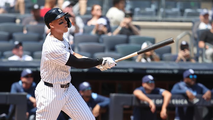 May 3, 2025; Bronx, New York, USA;  New York Yankees right fielder Aaron Judge (99) hits a solo home run in the first inning against the Tampa Bay Rays at Yankee Stadium.