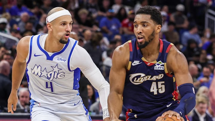 Mar 11, 2026; Orlando, Florida, USA; Cleveland Cavaliers guard Donovan Mitchell (45) drives to the basket against Orlando Magic guard Jalen Suggs (4) during the second half at Kia Center. Mandatory Credit: Mike Watters-Imagn Images