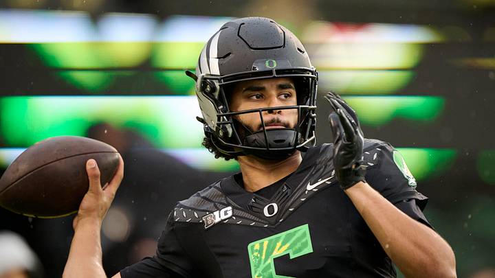 Oct 25, 2025; Eugene, Oregon, USA; Oregon Ducks quarterback Dante Moore (5) warms up before a game against the Wisconsin Badgers at Autzen Stadium. The Ducks are wearing uniforms celebrating the Grateful Dead. Oct 25, 2025; Eugene, Oregon, USA; Oregon Ducks quarterback Dante Moore (5) warms up before a game against the Wisconsin Badgers at Autzen Stadium. The Ducks are wearing uniforms celebrating the Grateful Dead.