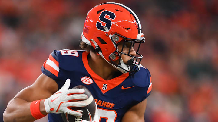 Nov 30, 2024; Syracuse, New York, USA; Syracuse Orange tight end Oronde Gadsden II (19) runs with the ball after a catch against the Miami Hurricanes during the first half at the JMA Wireless Dome. Mandatory Credit: Rich Barnes-Imagn Images Nov 30, 2024; Syracuse, New York, USA; Syracuse Orange tight end Oronde Gadsden II (19) runs with the ball after a catch against the Miami Hurricanes during the first half at the JMA Wireless Dome. Mandatory Credit: Rich Barnes-Imagn Images