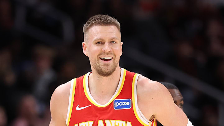 Kristaps Porzingis smiles as he runs back on defense