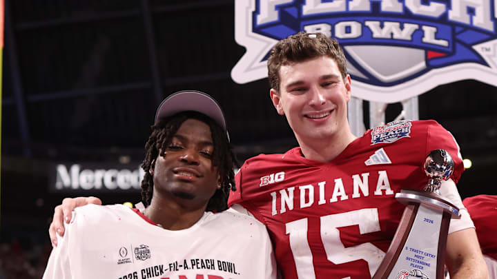 Jan 9, 2026; Atlanta, GA, USA; Indiana Hoosiers quarterback Fernando Mendoza (15) and Indiana Hoosiers defensive back D'Angelo Ponds (5) hold their trophies after the 2025 Peach Bowl and semifinal game of the College Football Playoff at Mercedes-Benz Stadium. Mandatory Credit: Brett Davis-Imagn Images