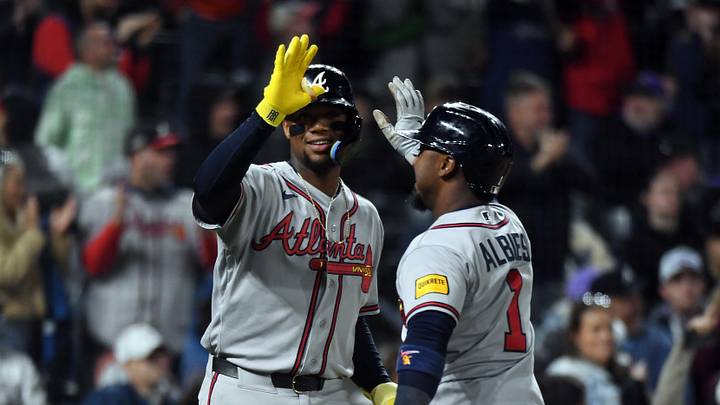 May 1, 2026; Denver, Colorado, USA; Atlanta Braves outfielder Ronald Acuna Jr. (13) and infielder Ozzie Albies (1) celebrate after scoring during the eighth inning against the Colorado Rockies at Coors Field. Mandatory Credit: Christopher Hanewinckel-Imagn Images