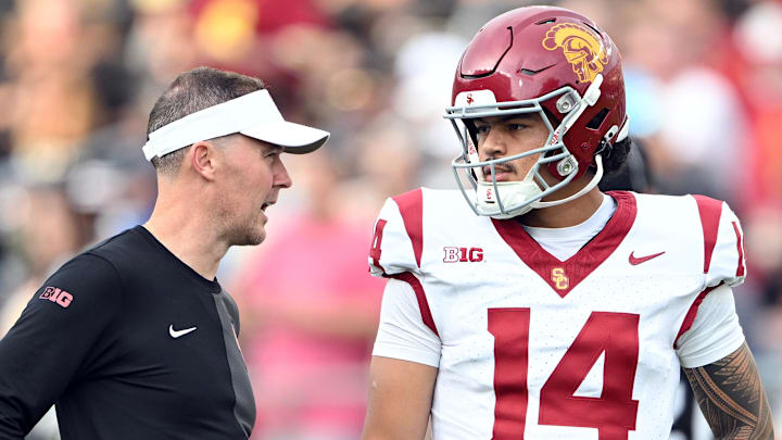 Sep 13, 2025; West Lafayette, Indiana, USA;  Southern California Trojans quarterback Jayden Maiava (14) talks with Southern California Trojans head coach Lincoln Riley  before the game against the Purdue Boilermakers at Ross-Ade Stadium. Mandatory Credit: Marc Lebryk-Imagn Images