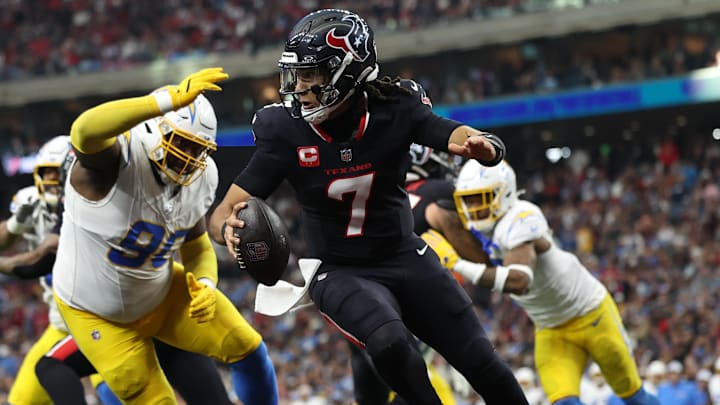 Jan 11, 2025; Houston, Texas, USA; Houston Texans quarterback C.J. Stroud (7) avoids a tackle by Los Angeles Chargers defensive tackle Teair Tart (90) during the second quarter in an AFC wild card game at NRG Stadium. Mandatory Credit: Troy Taormina-Imagn Images Jan 11, 2025; Houston, Texas, USA; Houston Texans quarterback C.J. Stroud (7) avoids a tackle by Los Angeles Chargers defensive tackle Teair Tart (90) during the second quarter in an AFC wild card game at NRG Stadium. Mandatory Credit: Troy Taormina-Imagn Images