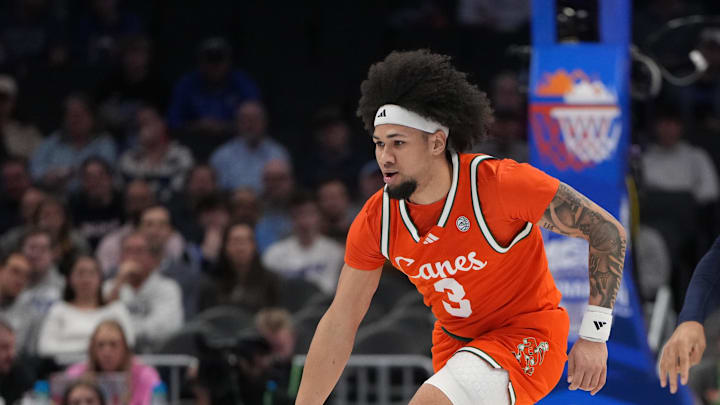 Mar 13, 2026; Charlotte, NC, USA; Miami (FL) Hurricanes guard Tre Donaldson (3) dribbles as Virginia Cavaliers guard Malik Thomas (1) defends in the first half at Spectrum Center. Mandatory Credit: Bob Donnan-Imagn Images