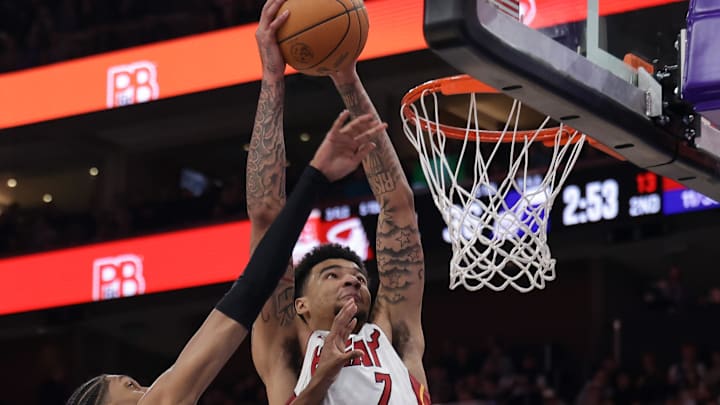 Jan 9, 2025; Salt Lake City, Utah, USA;  Miami Heat center Kel'el Ware (7) dunks the ball over Utah Jazz forward Cody Williams (5) during the second quarter at Delta Center. Mandatory Credit: Chris Nicoll-Imagn Images