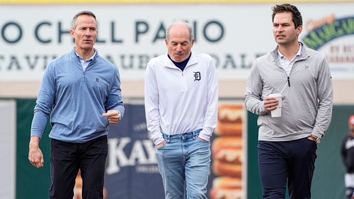 Detroit Tigers owner Chris Ilitch, left, talks to Rob Harris, center, and president of baseball operation Scott Harris during spring training at Joker Marchant Stadium in Lakeland, Fla. on Thursday, Feb. 20, 2025.