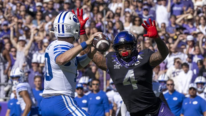 Oct 14, 2023; Fort Worth, Texas, USA; Brigham Young Cougars quarterback Kedon Slovis (10) and TCU Horned Frogs linebacker Namdi Obiazor (4) in action during the game between the TCU Horned Frogs and the Brigham Young Cougars at Amon G. Carter Stadium. Mandatory Credit: Jerome Miron-Imagn Images