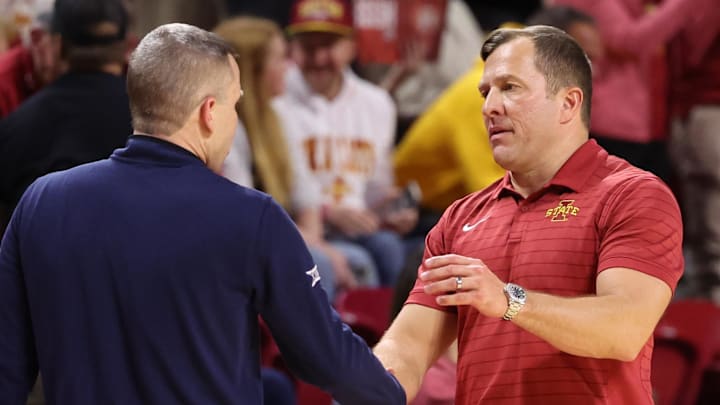 Jan 2, 2026; Ames, Iowa, USA; Iowa State Cyclones head coach T.J. Otzelberger meets with West Virginia Mountaineers head coach Ross Hodge after the Cyclones victory at James H. Hilton Coliseum. 