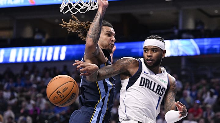 Oct 7, 2024; Dallas, Texas, USA; Dallas Mavericks guard Jaden Hardy (1) passes the ball by Memphis Grizzlies forward Brandon Clarke (15) during the second quarter at the American Airlines Center. Mandatory Credit: Jerome Miron-Imagn Images