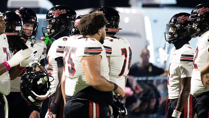 Palmetto players gather on the sideline during the Tigers' 37-14 victory over rival Manatee on October 9, 2026, in Bradenton, Florida. Palmetto players gather on the sideline during the Tigers' 37-14 victory over rival Manatee on October 9, 2026, in Bradenton, Florida.