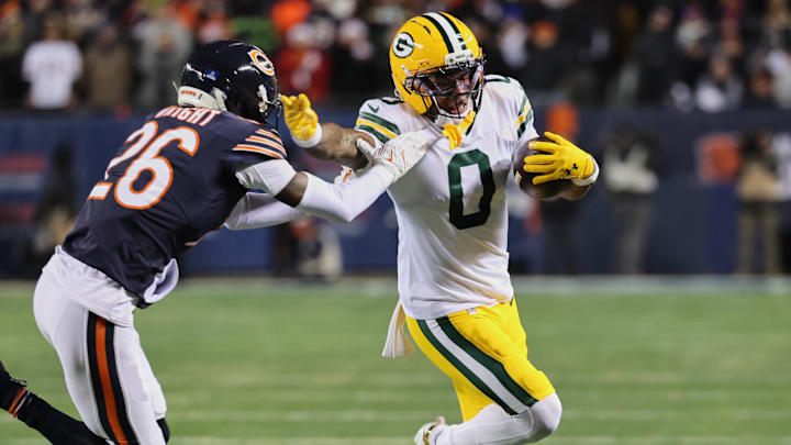 Dec 20, 2025; Chicago, Illinois, USA; Green Bay Packers wide receiver Matthew Golden (0) runs with the ball against Chicago Bears cornerback Nahshon Wright (26) during the first quarter at Soldier Field. Mandatory Credit: Mike Dinovo-Imagn Images