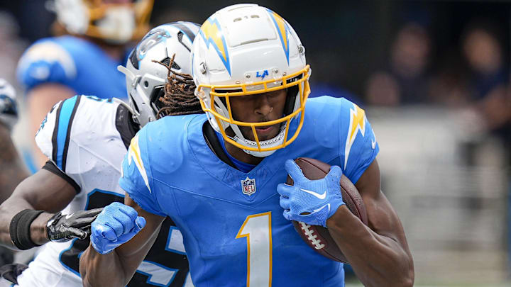 Sep 15, 2024; Charlotte, North Carolina, USA; Los Angeles Chargers wide receiver Quentin Johnston (1) runs out of bounds chased by Carolina Panthers safety Xavier Woods (25) during the second half at Bank of America Stadium. Mandatory Credit: Jim Dedmon-Imagn Images