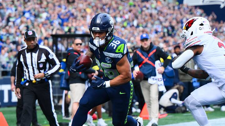 Nov 9, 2025; Seattle, Washington, USA;  Seattle Seahawks running back George Holani (36) rushes for a touchdown as Arizona Cardinals safety Budda Baker (3) defends during the first quarter at Lumen Field. Mandatory Credit: Steven Bisig-Imagn Images