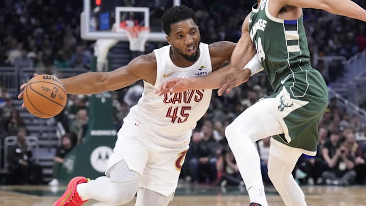Nov 2, 2024; Milwaukee, Wisconsin, USA; Cleveland Cavaliers guard Donovan Mitchell (45) drives to the basket against Milwaukee Bucks guard Andre Jackson Jr. (44) in the first half at Fiserv Forum. Mandatory Credit: Michael McLoone-Imagn Images