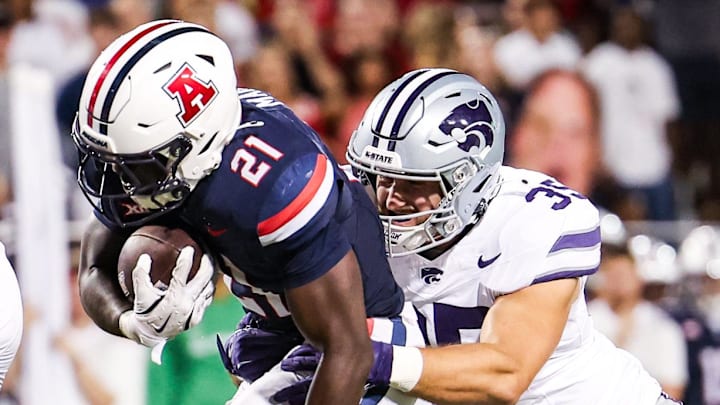Sep 12, 2025; Tucson, Arizona, USA; Kansas State Wildcats linebacker Gabe Powers (35) tackles Arizona Wildcats running back Ismail Mahdi (21) during the second quarter of the game at Arizona Stadium. Mandatory Credit: Aryanna Frank-Imagn Images