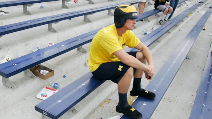 A Michigan fan sits in disbelief after the loss to Oregon in the Big House in 2007.
