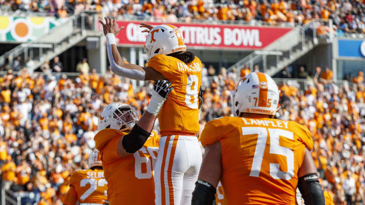 Jan 1, 2024; Orlando, FL, USA; Tennessee Volunteers quarterback Nico Iamaleava (8) and offensive lineman Masai Reddick (68) celebrate a touchdown against the Iowa Hawkeyes during the second quarter at Camping World Stadium. Mandatory Credit: Morgan Tencza-USA TODAY Sports