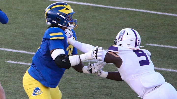 Delaware quarterback Nick Minicucci (4) throws in front of Anwar O'neal as he blocks against Albany's Ibrahim Sanogo in the third quarter of the Blue Hens' 28-14 win at Delaware Stadium, Saturday, Oct. 26, 2024.