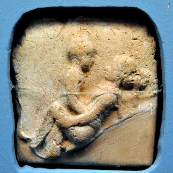 rock carving showing a man on top of a woman